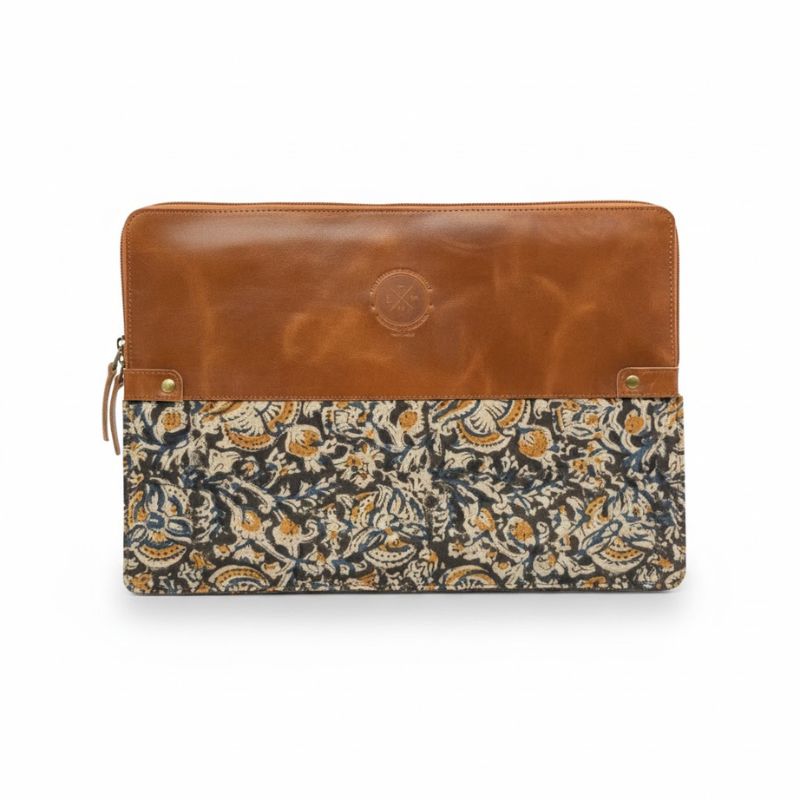 Floral patterned pouch with brown leather top on a white background