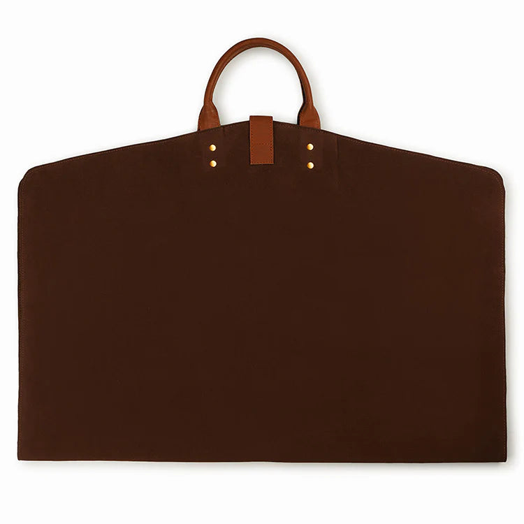 Brown garment bag with leather handle and trim on a white background