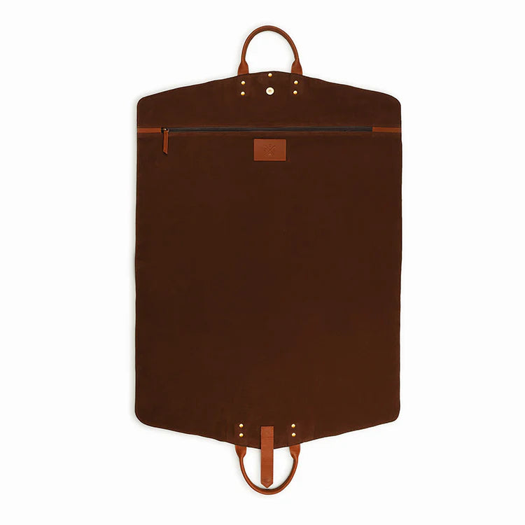 Brown garment bag with leather straps on a white background