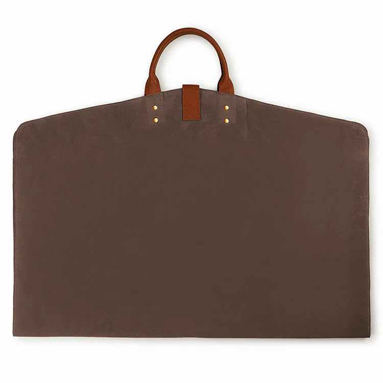 Brown garment bag with leather handles on a white background