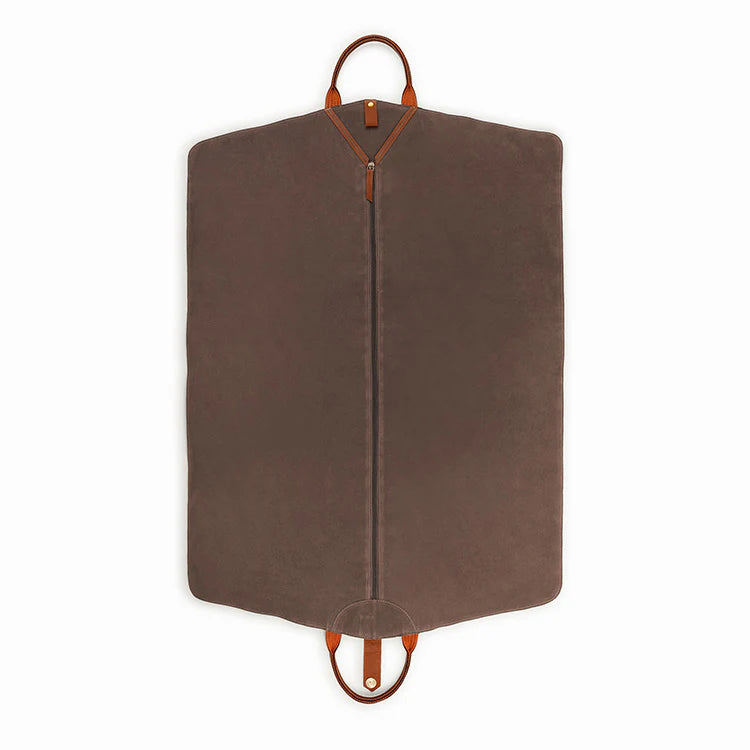 Brown garment bag with leather handles on a white background