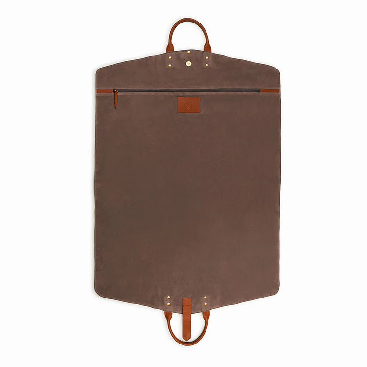 Brown garment bag with leather straps on a white background