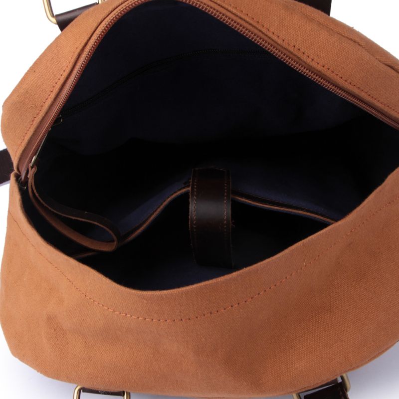 Brown leather bag with a visible zipper on a white background