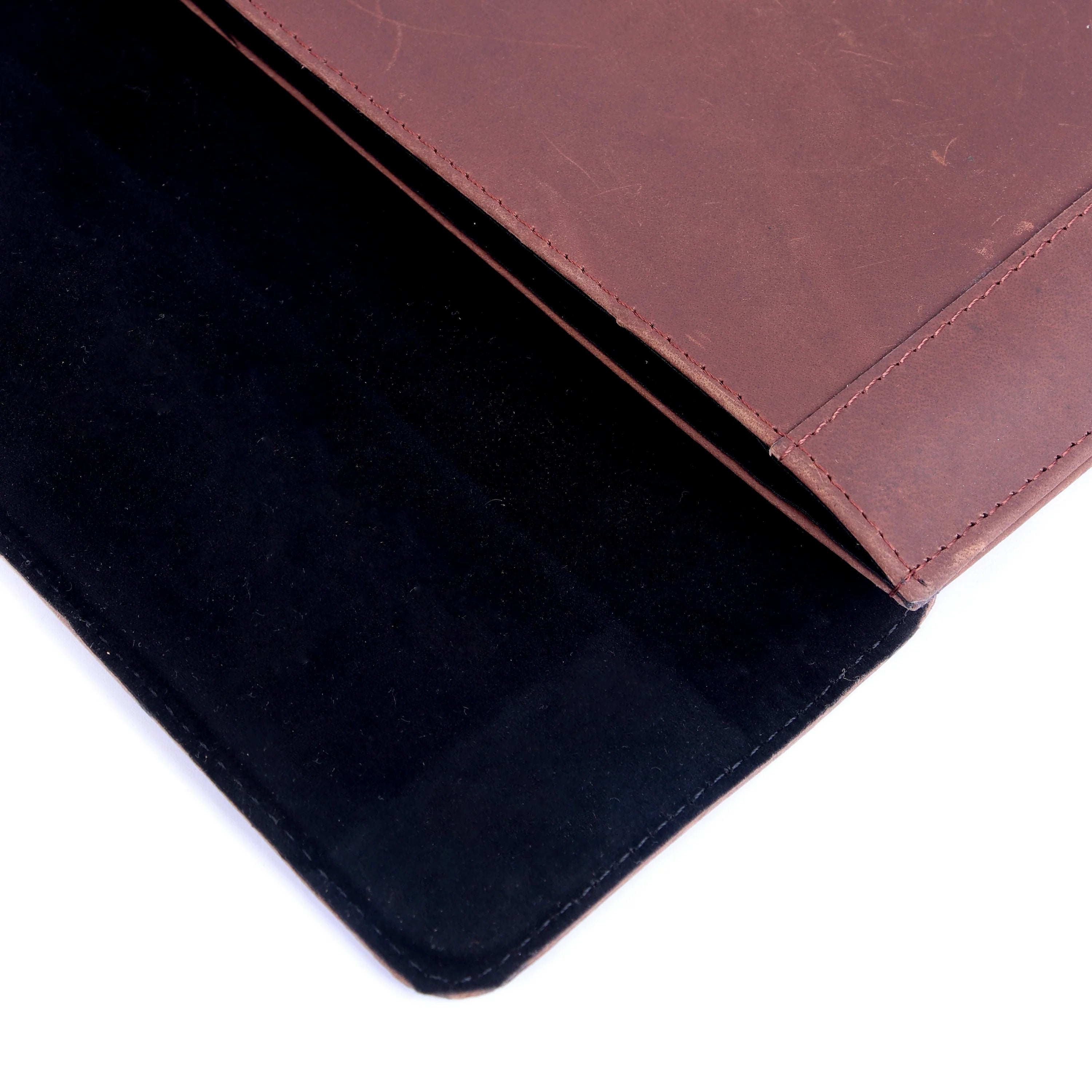 Close-up of a brown leather wallet with a black interior on a white background