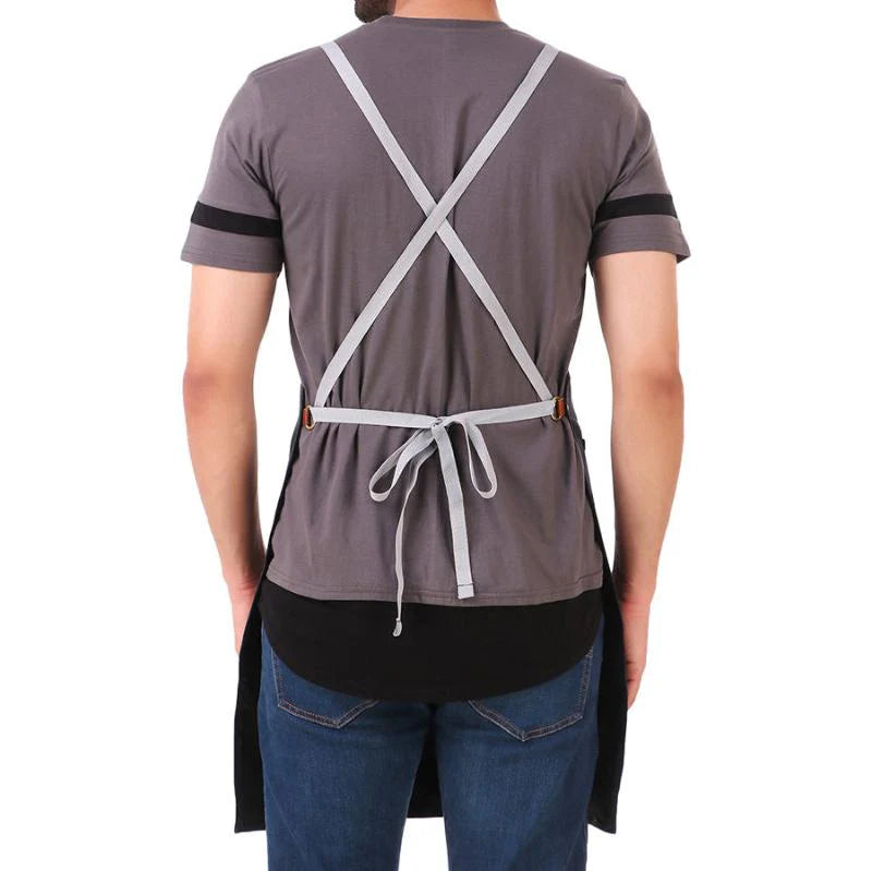 Person wearing a gray apron with cross straps on a white background