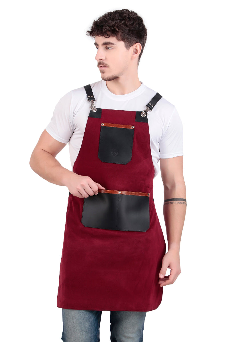 Man wearing a red apron with black leather pockets on a white background