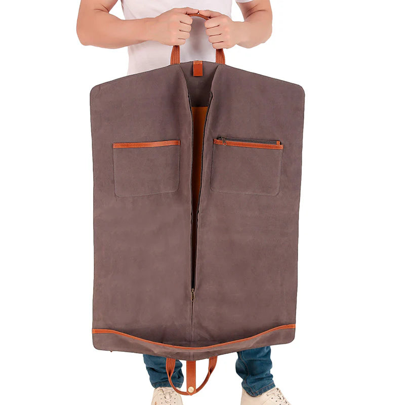Person holding a brown garment bag with orange accents on a white background