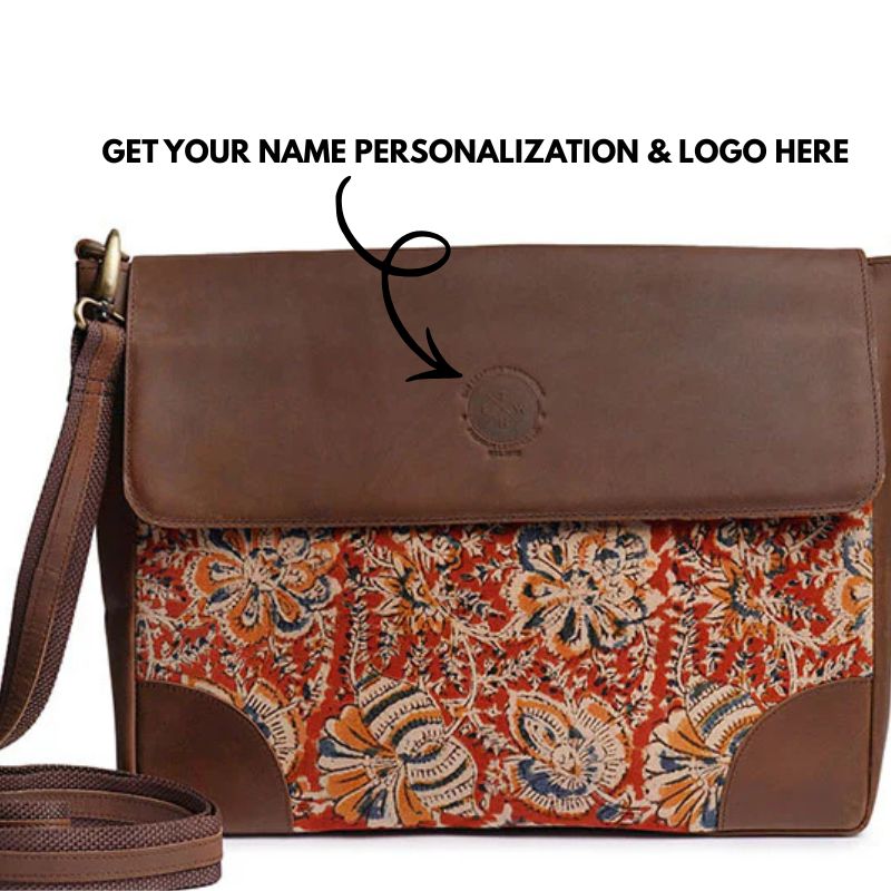 Brown leather handbag with a colorful paisley pattern on a white background