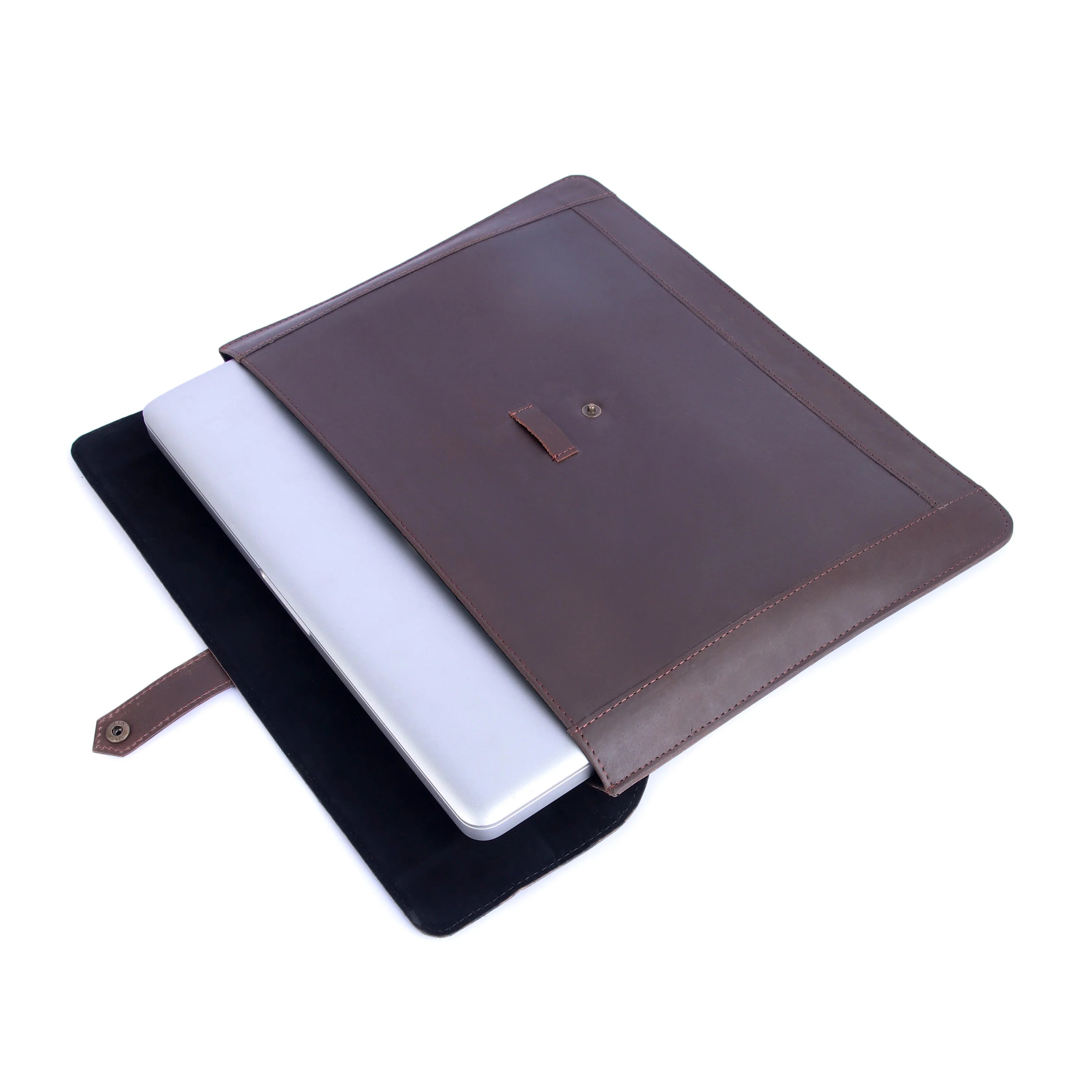 Brown leather laptop sleeve with a white laptop inside on a white background
