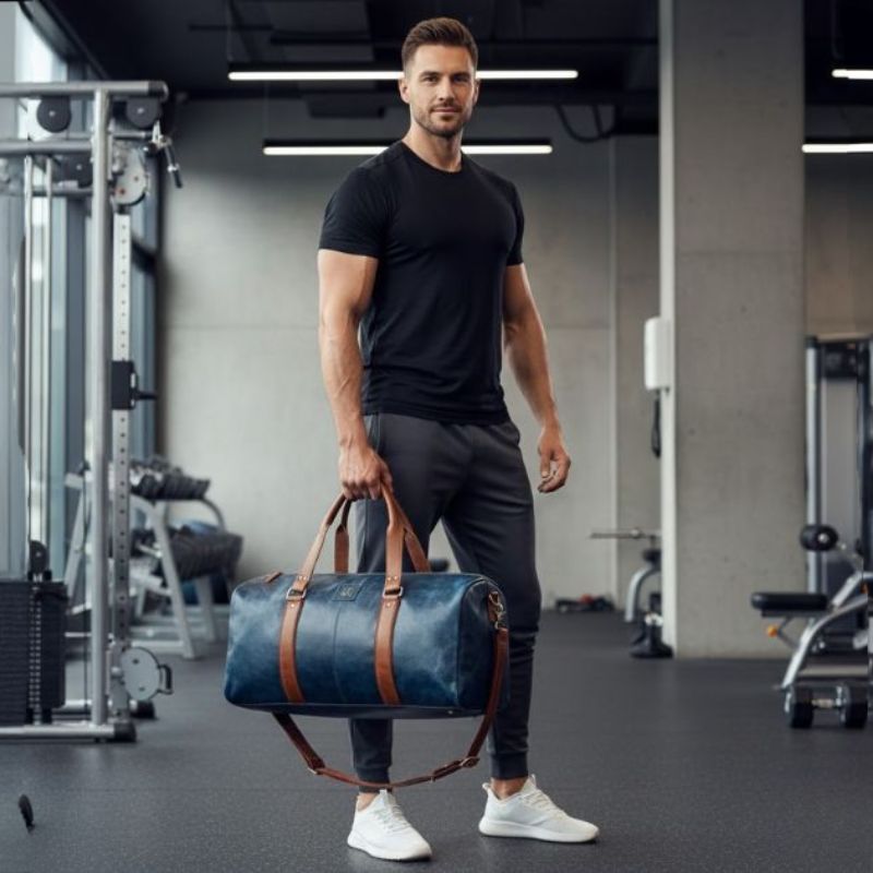 Man holding a blue duffel bag in a gym setting