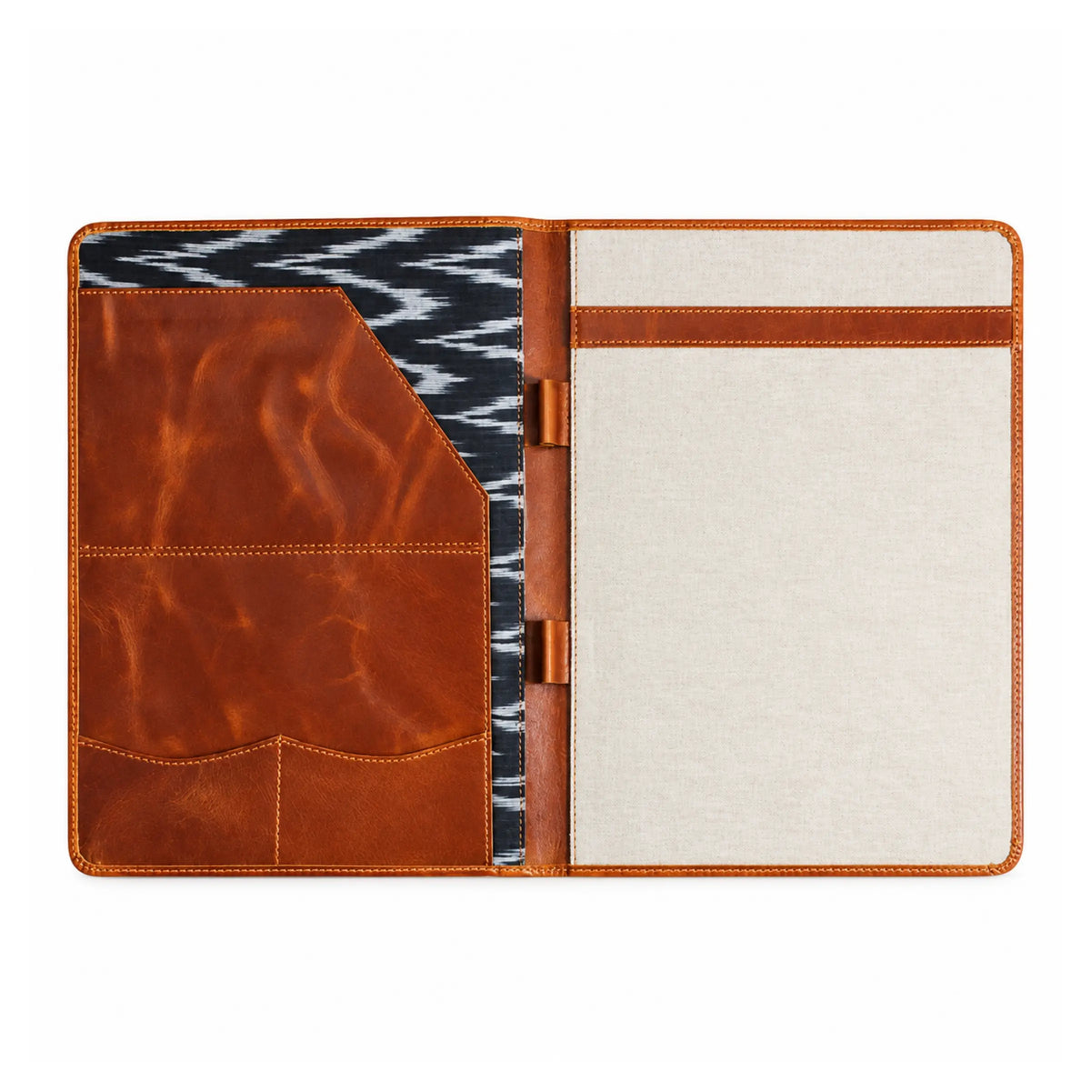 Open brown leather and canvas folder featuring document pockets, pen holders, and a black and white patterned interior