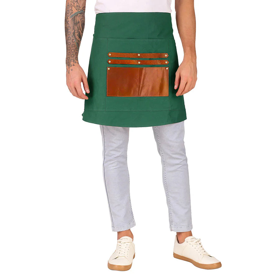 Person wearing a green apron with brown leather pockets on a white background