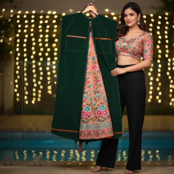 Woman holding a green jacket over a floral outfit with a blurred lights background