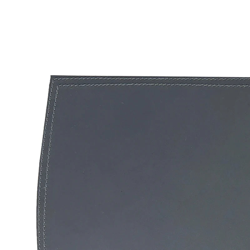 Dark gray leather surface with visible stitching on a white background