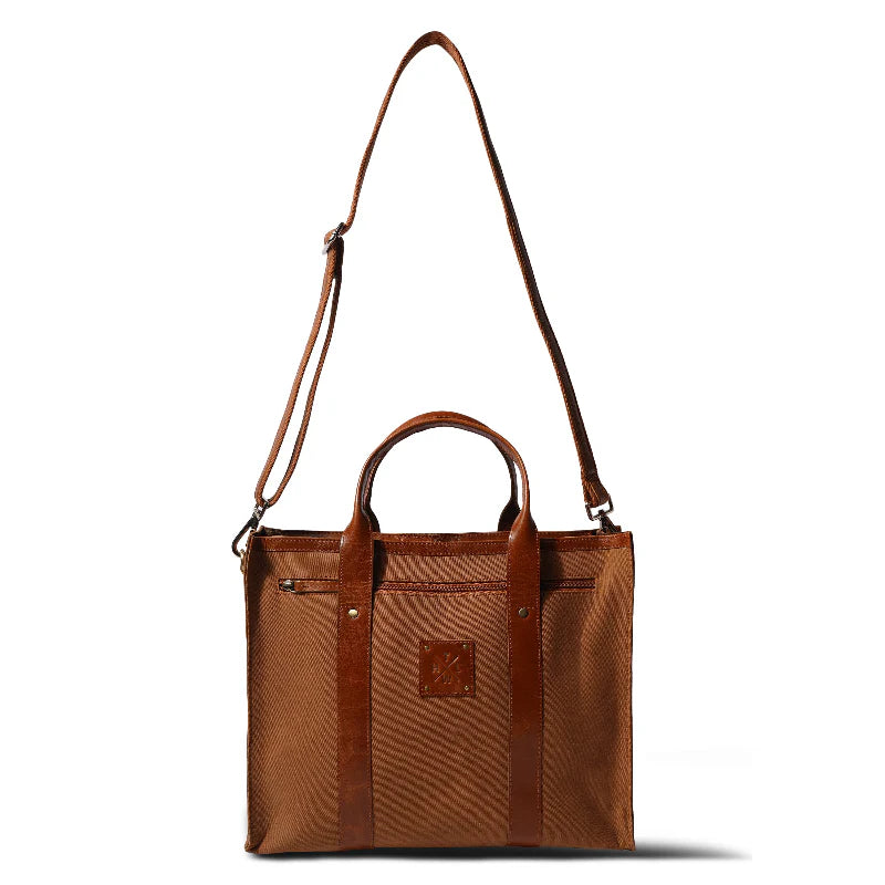 Brown leather handbag with a shoulder strap on a white background