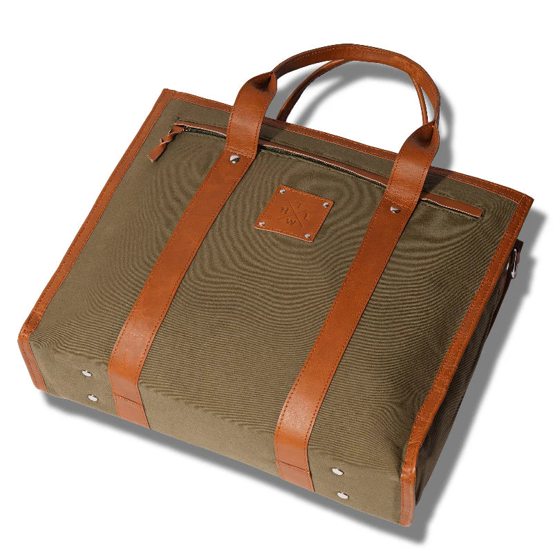 Green bag with brown leather straps on a white background