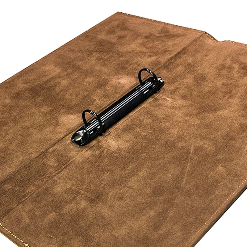 Brown leather wallet with a black metal clip on a white background