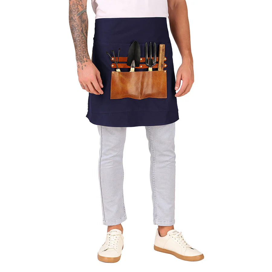 Person wearing a navy apron with a brown leather tool belt on a white background