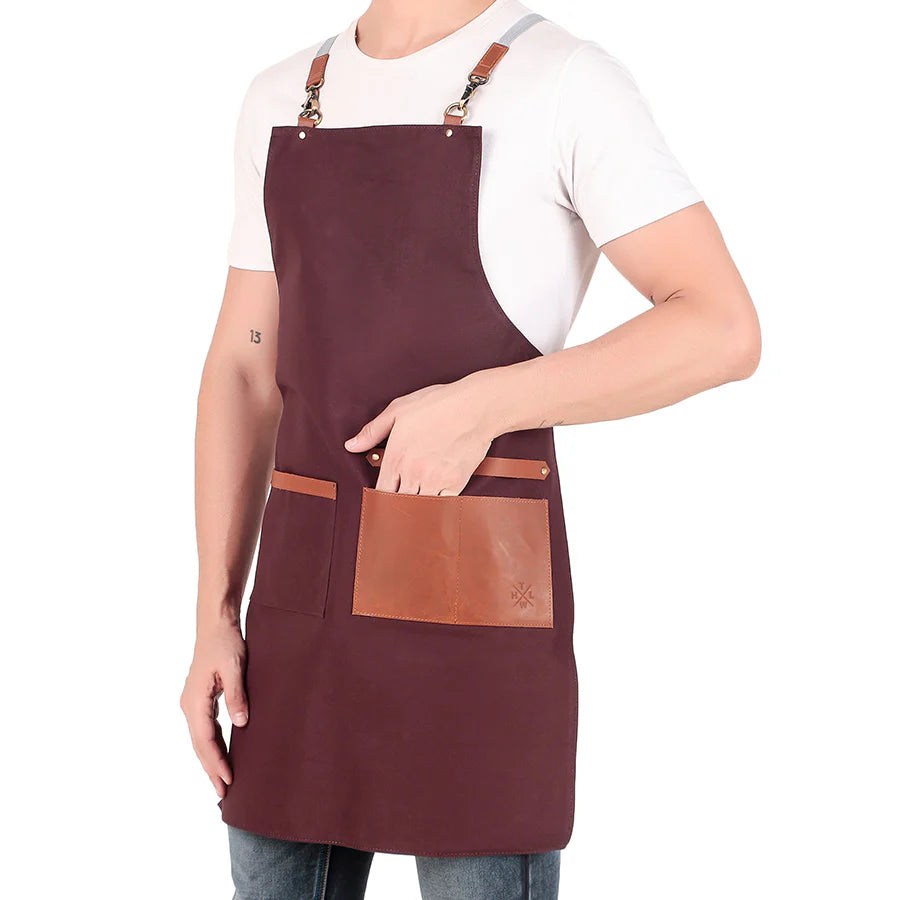 Person wearing a brown apron with a leather pocket on a white background