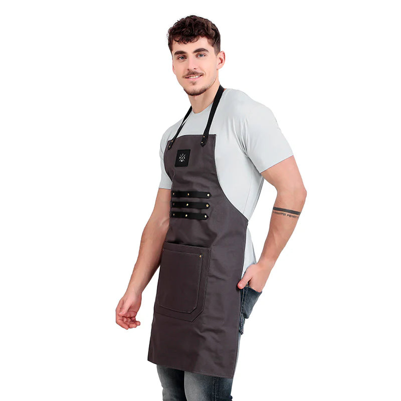 Man wearing a gray apron on a white background