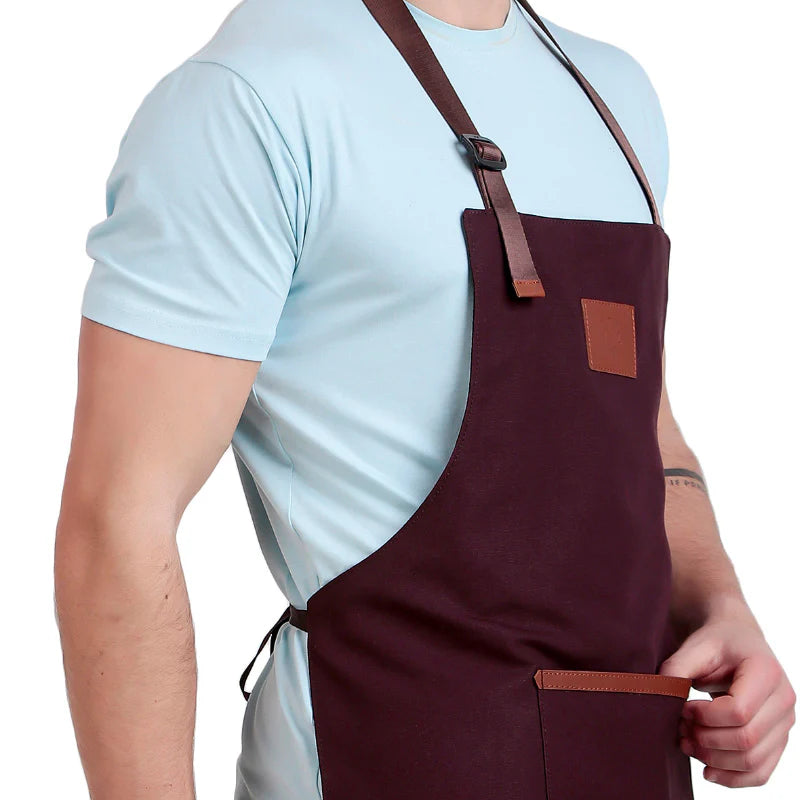 Person wearing a maroon apron with brown straps on a white background