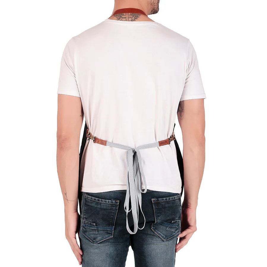 Person wearing a white t-shirt and blue jeans with a gray apron over their shoulders on a white background