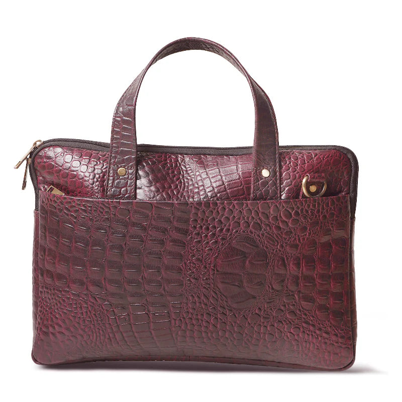 Maroon leather handbag with crocodile texture on a white background