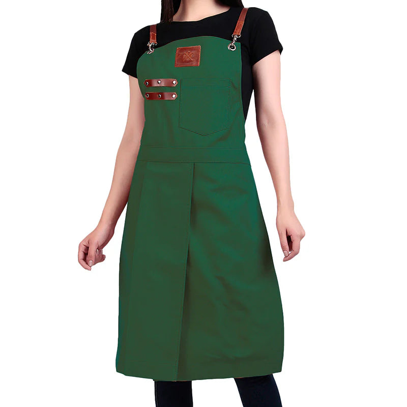 Green apron with brown straps worn by a person on a white background