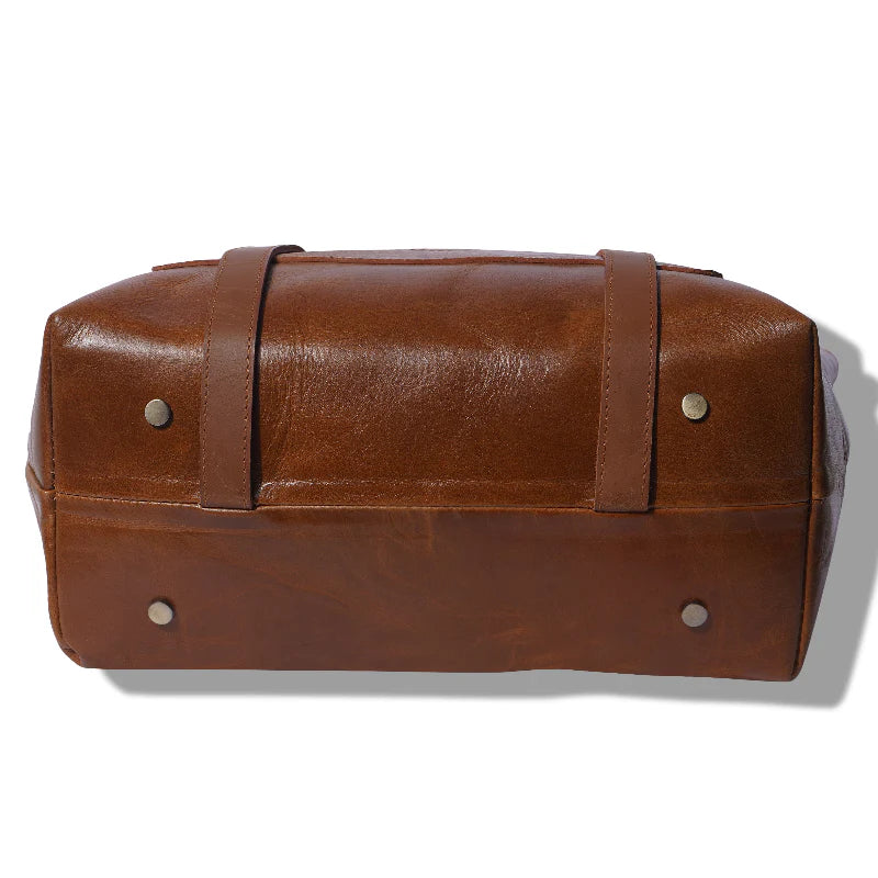 Brown leather bag with straps on a white background