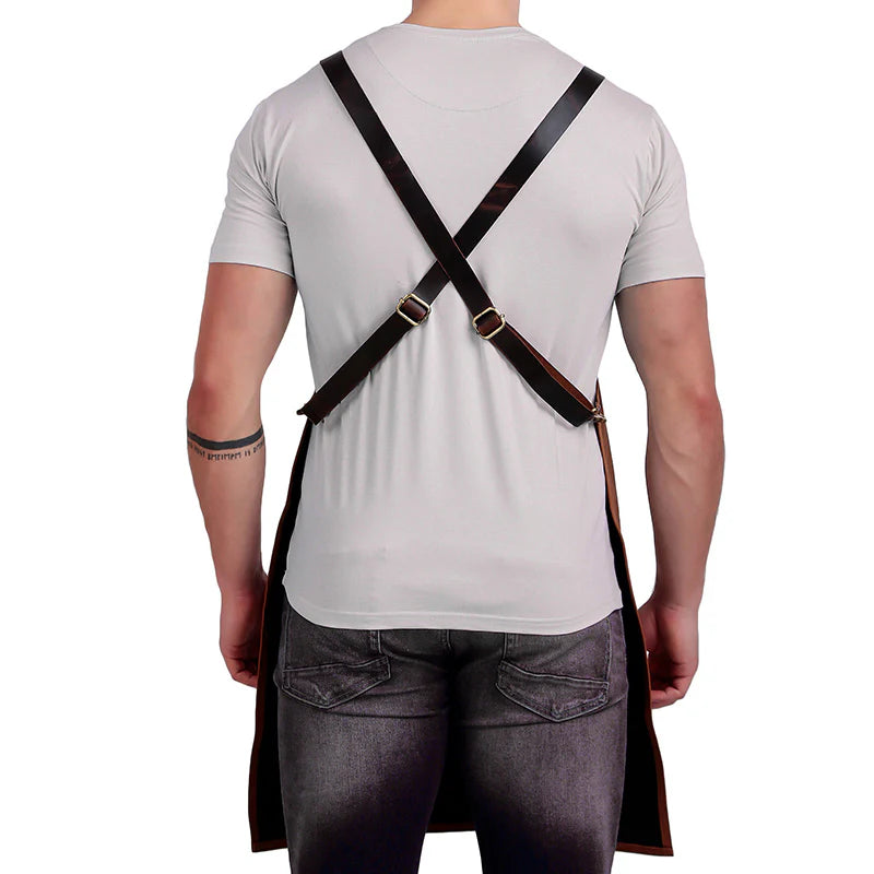 Person wearing a black apron with a white shirt and gray pants on a white background