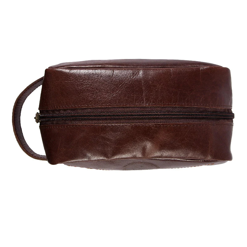 Brown leather toiletry bag with a strap on a white background