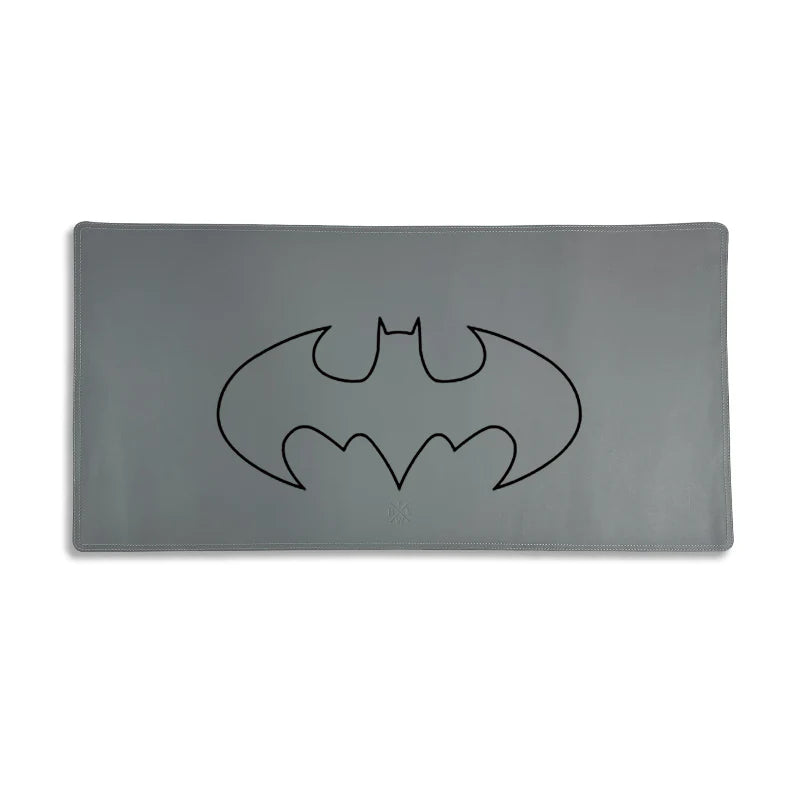 Gray mouse pad with a black Batman logo on a white background