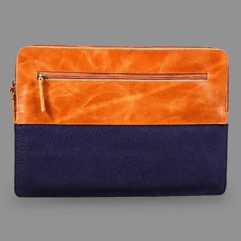 Two-tone orange and navy leather clutch bag on a gray background