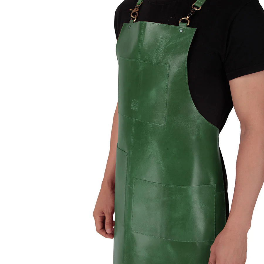 Green apron worn by a person on a white background