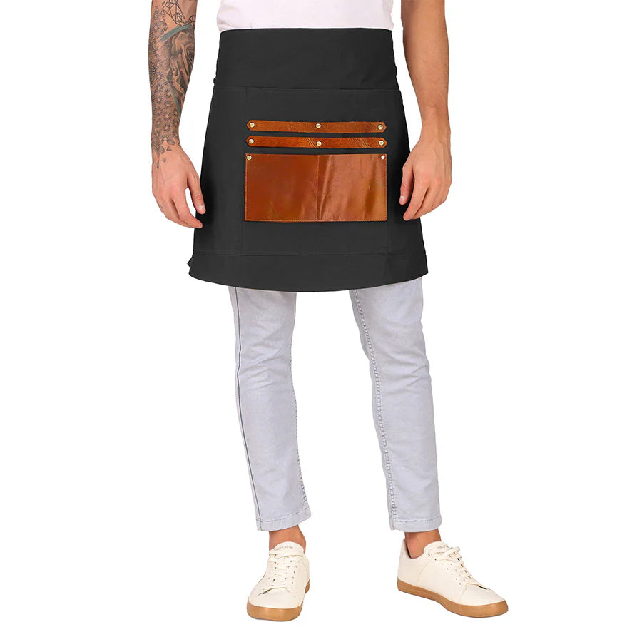 Person wearing a black apron with brown leather pockets on a white background