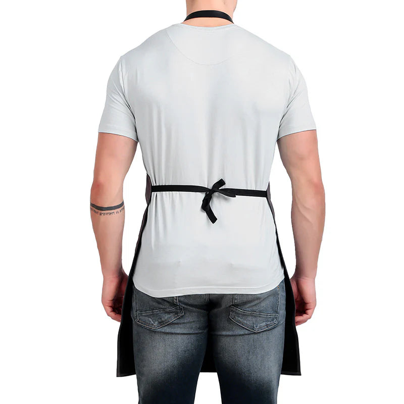 Person wearing a white apron over a gray t-shirt on a white background