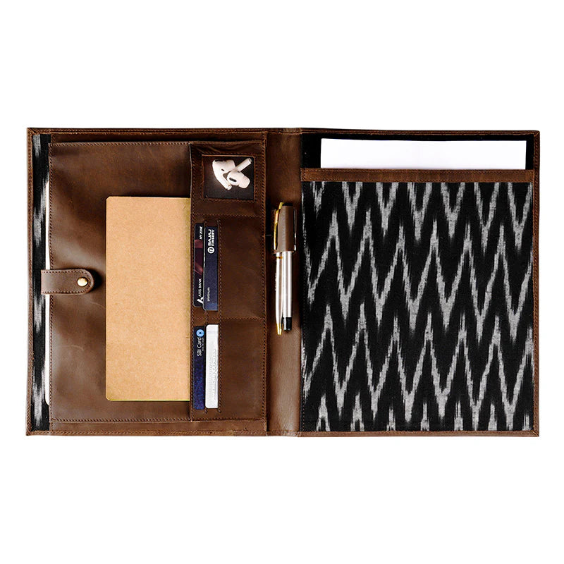 Brown leather organizer with compartments on a white background