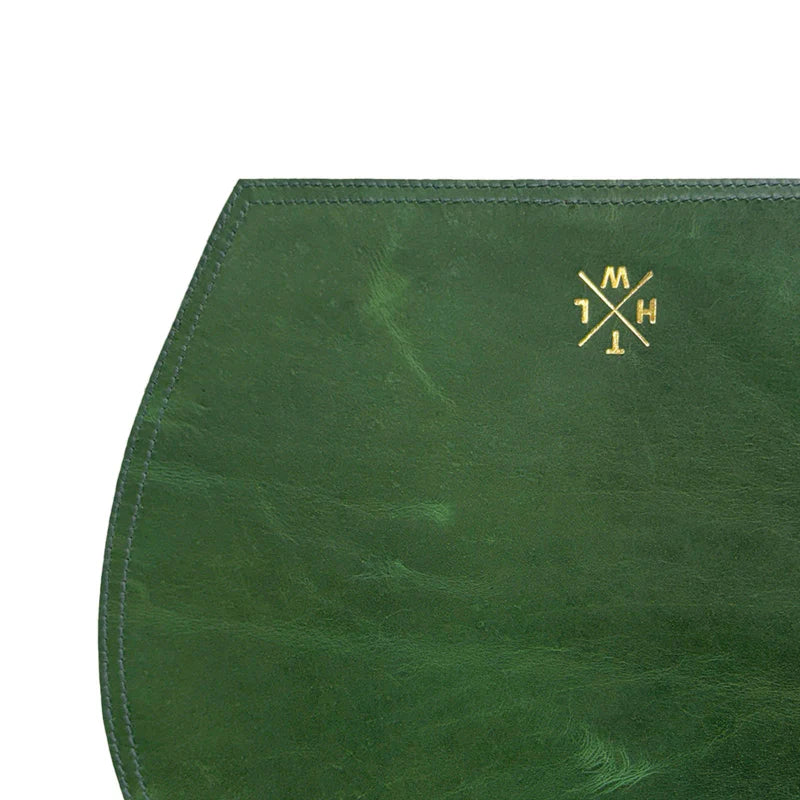 Green leather product with a gold logo on a white background