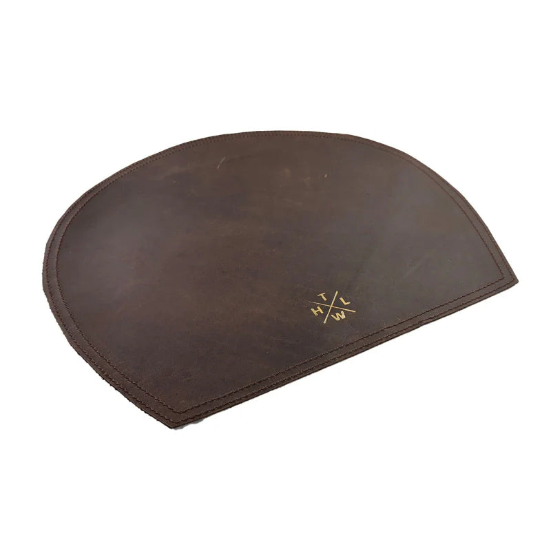 Brown leather half-circle mat with a logo on a white background