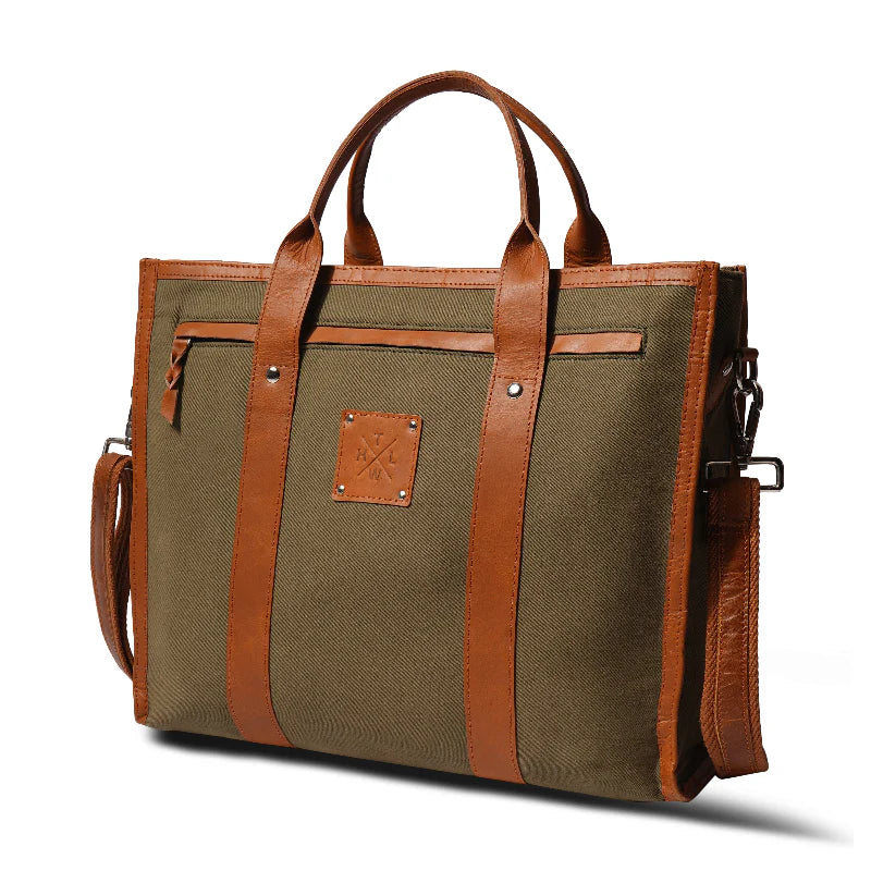 Green canvas briefcase with brown leather straps and accents on a white background