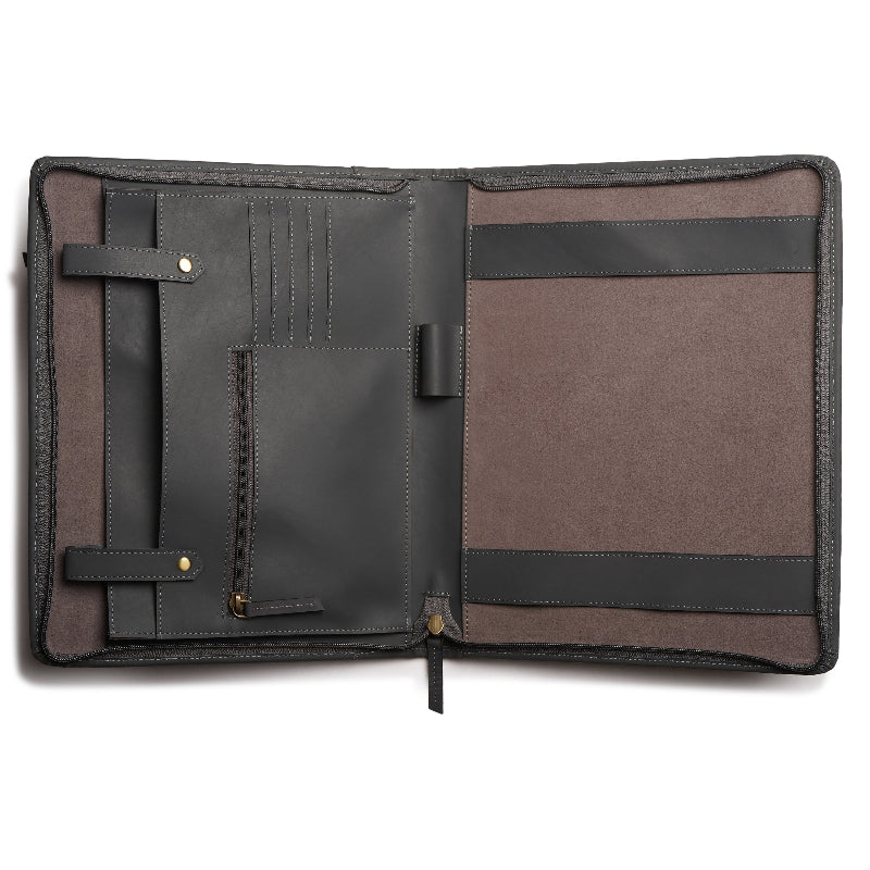 Open leather portfolio with black and brown interior on a white background