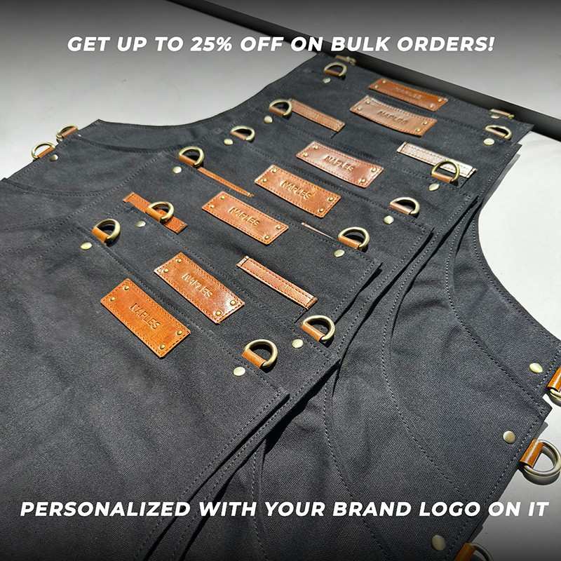 Black apron with brown leather nameplates and gold hardware, promotional text overlay.