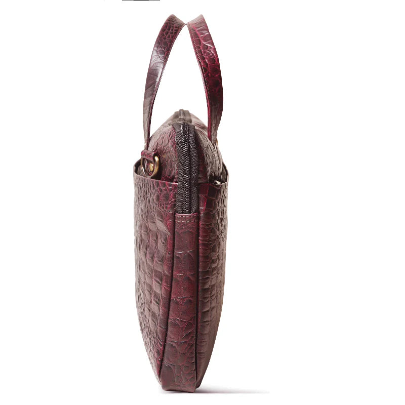 Red handbag with a textured pattern on a white background