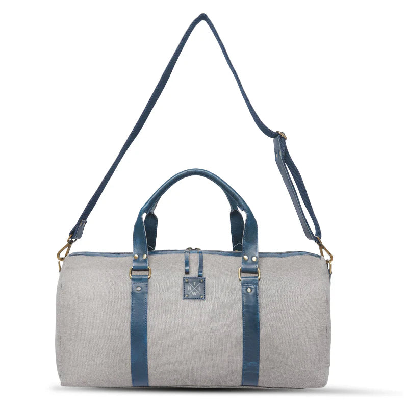 Gray duffel bag with blue straps on a white background