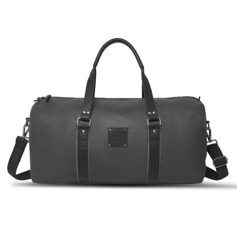 Black duffel bag with straps on a white background