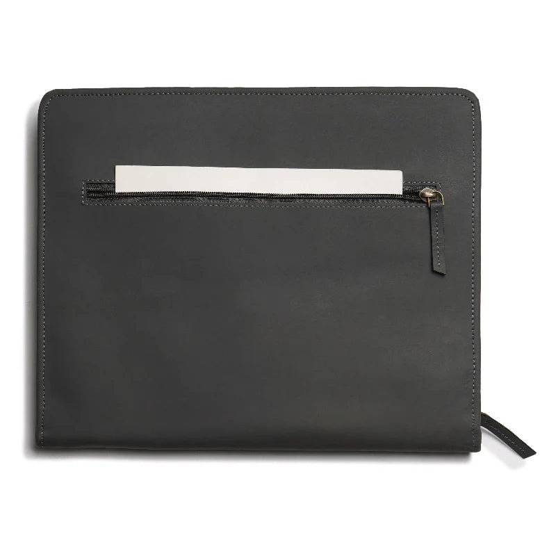 Black leather clutch with a white interior pocket on a white background
