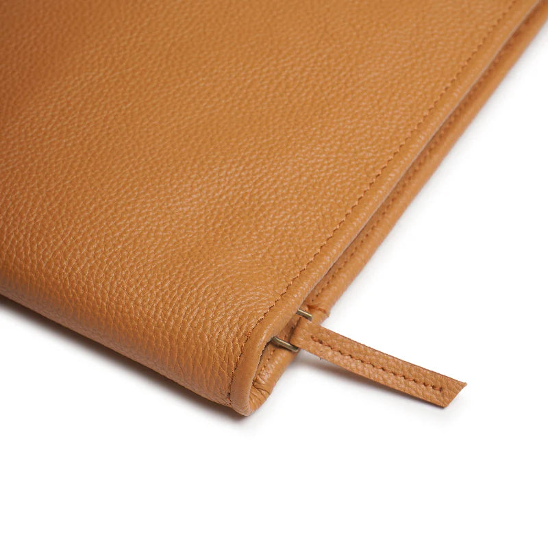 Close-up of a brown leather product with a white background