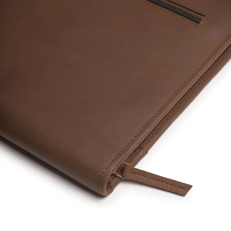 Close-up of a brown leather portfolio on a white background