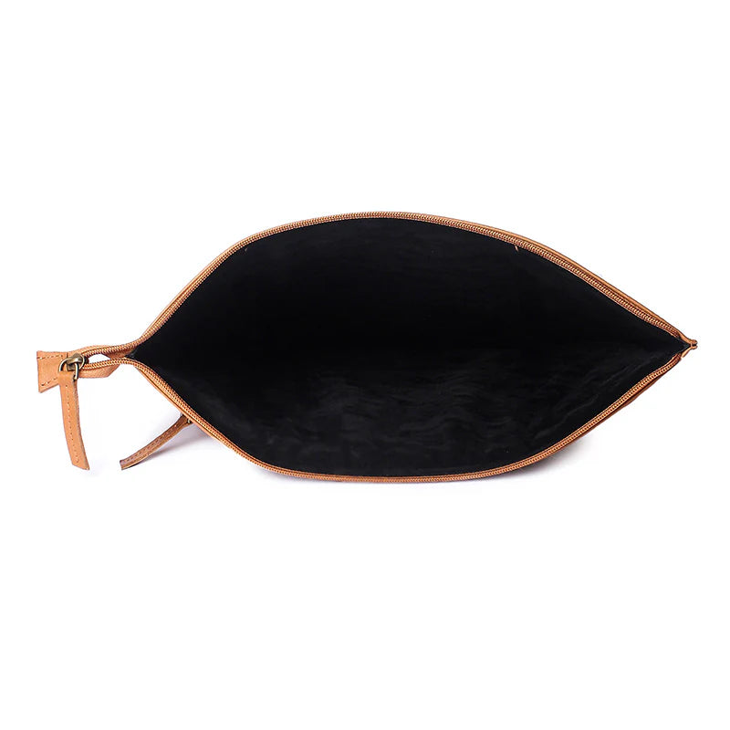 Open brown leather clutch bag with black interior on a white background