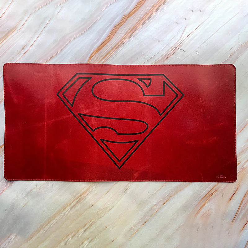 Red Superman logo placemat on a marble surface